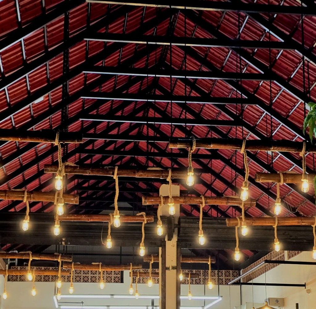 Chai Hut interior ceiling with bamboo beams and warm Edison bulb lights